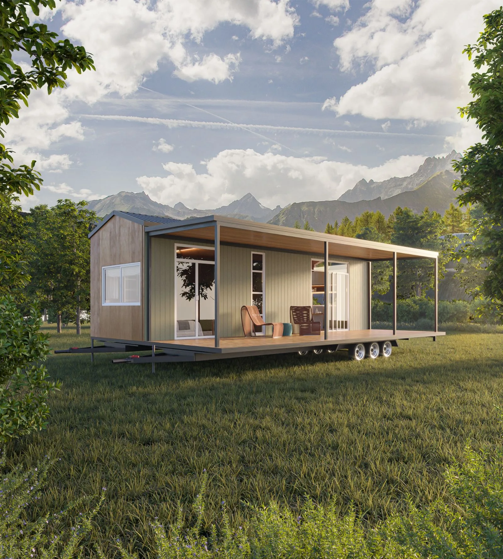 The Ember tiny home on its deck in a meadow, with mountains behind